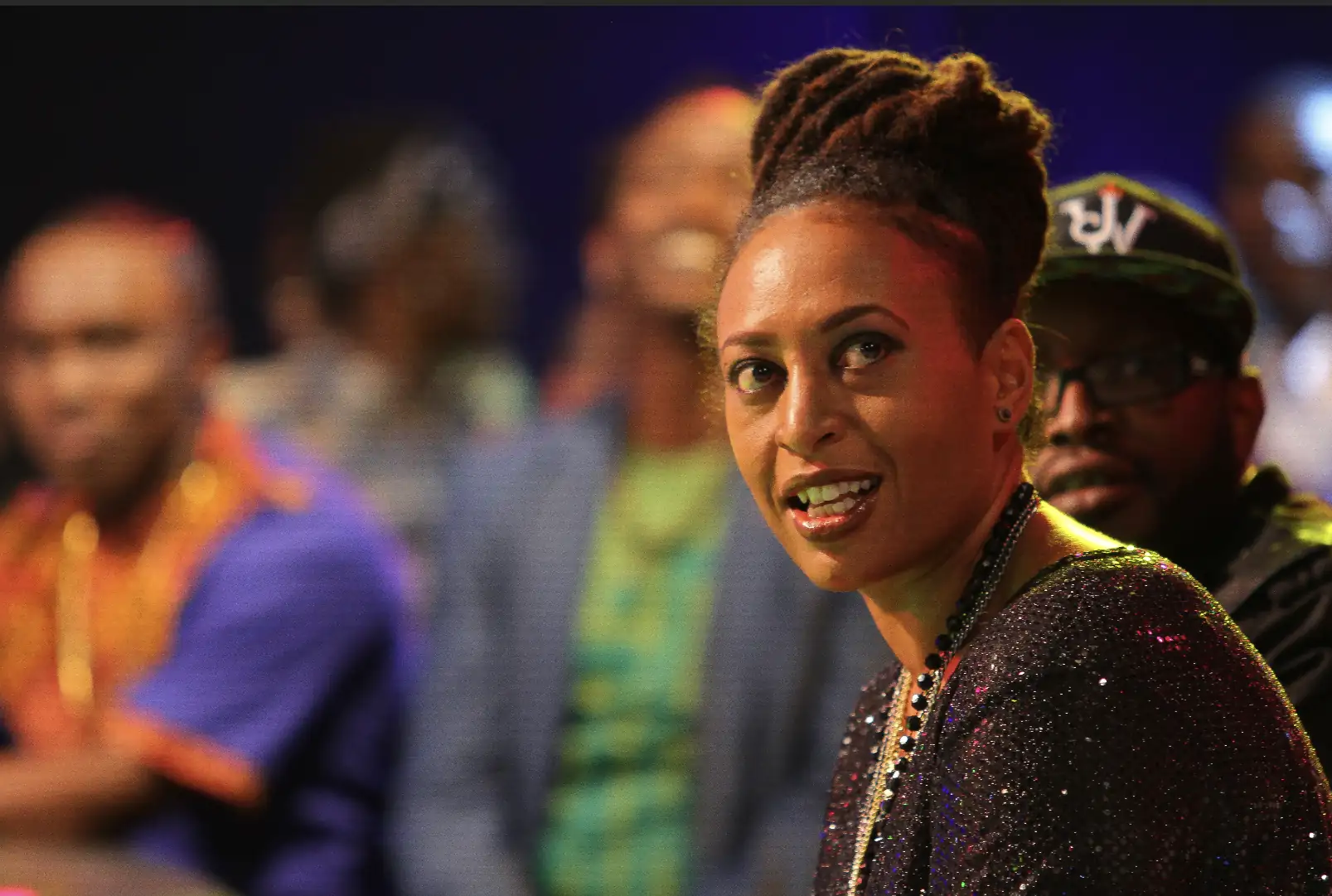 Close-up of a woman with dreadlocks at an indoor concert event